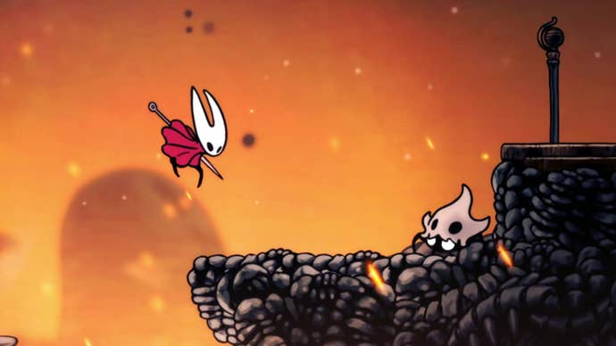 Hornet leaps through a rocky lava-filled landscape in Hollow Knight: Silksong, and prepares to attack a scuttling skull-wearing enemy creature.